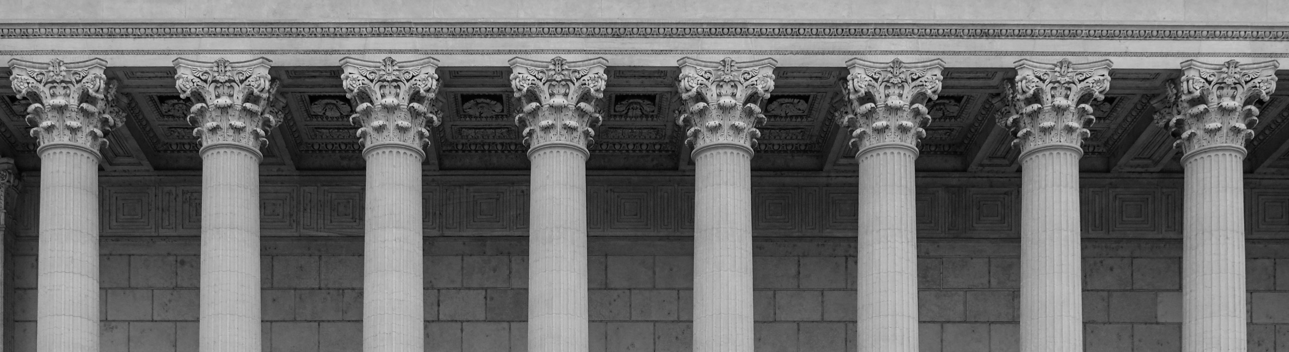 Farrell Thurman & Flammer, P.C. signature banner of courthouse pillars in black and white.
